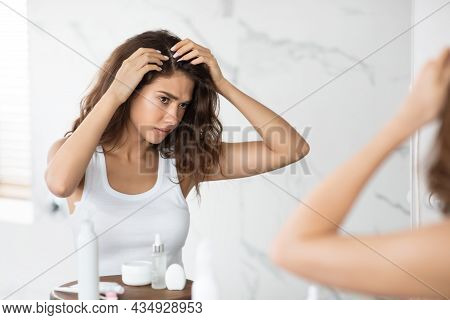 Frustrated Lady Searching Hair Flakes Suffering From Dandruff Problem Indoors