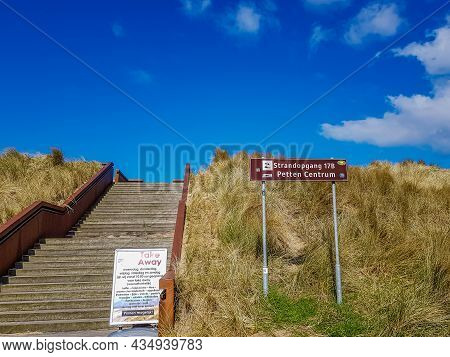 Petten Aan Zee, Noord-holland, Netherlands. April 17, 2021. Stairs Above The Dike At The Entrance To
