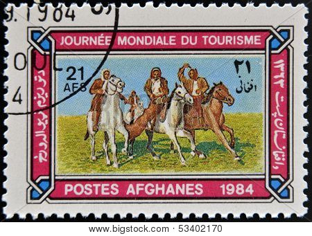AFGHANISTAN - CIRCA 1984: A stamp printed in Afghanistan shows Horsemen playing Tourism buzkashi