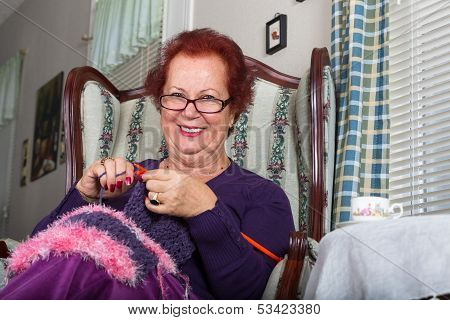 Senior Lady Looking At You While Knitting