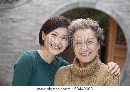 Grandmother and granddaughter in front of round arch