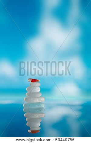 sea glass seaglass pile pyramid with reflection and seascape, shallow dof