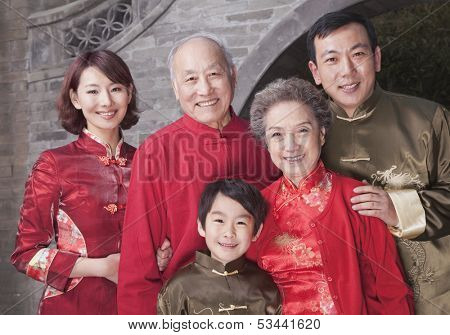 Multi-generation family portrait by traditional Chinese building