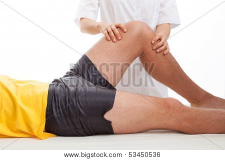 Physiotherapist Massaging A Leg