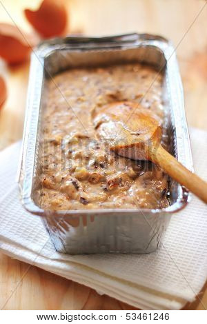 Mix Of Flour, Eggs, Bananas And Chopped Dark Chocolate And Walnuts In Aluminum Baking Tin