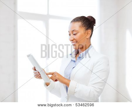 office, business, technology and internet concept - businesswoman with tablet pc in office