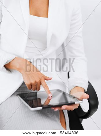 office, business, technology and internet concept - businesswoman with tablet pc in office