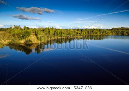 Landscape with blue sky and smooth lake surface