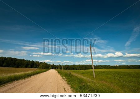 Summer country road lane and deep blue sky