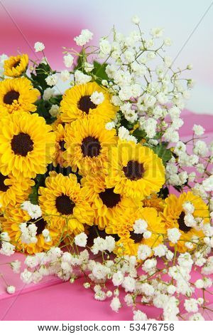 Beautiful flowers on table on bright background
