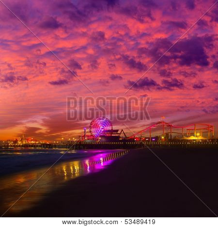 Santa Monica California sunset on Pier Ferris wheel and reflection on beach wet sand