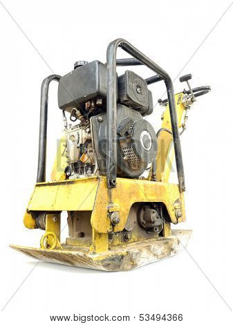 Old yellow plate compactor isolated on white