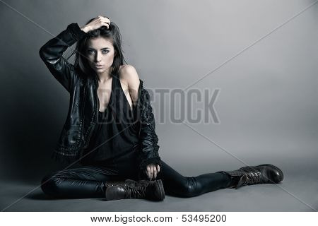Fashion model wearing leather pants and jacket