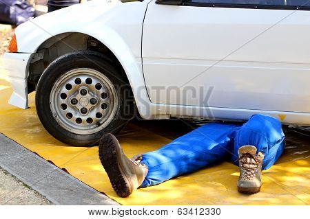 Mechanic With The Suit From Work While Repairing The Engine