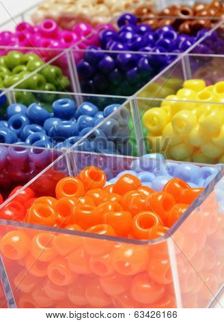 Closeup of beads in bins separated for making crafts jewelry