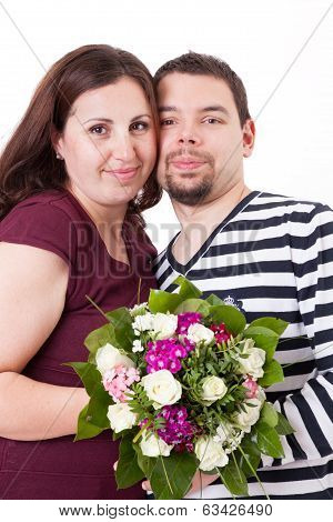 Happy Couple Smiling With Bouquet Of Flowers