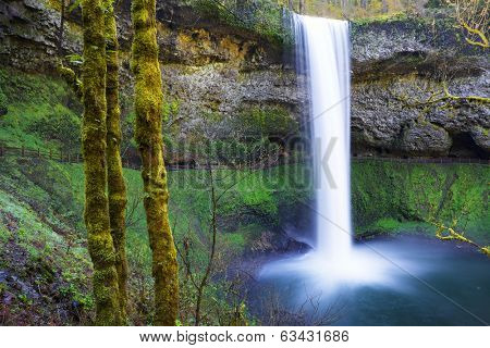 South Falls at Silver Falls Park in Oregon with water falling into a pond done with slow exposure