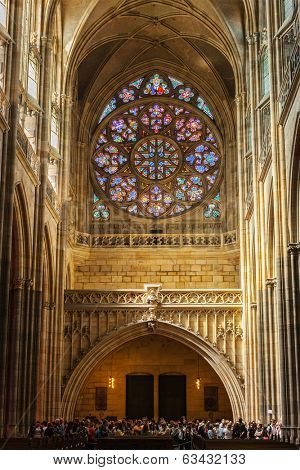 PRAGUE, CZECH REPUBLIC - APRIL 27, 2012: Interior of St. Vitus cathedral with rose window above the main entrance designed by Frantisek Kysela and with tourist crowd inside, Prague, Czech republic