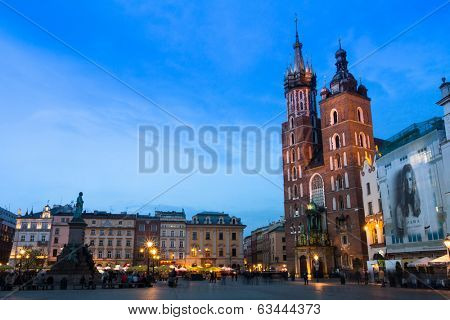 KRAKOW, POLAND - APR 7, 2014: St. Mary's Church on Rynek Glowny (Market Square) in night time. Rynek Glowny - roughly 40,000 m2 is largest medieval town square in Europe.