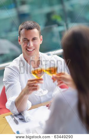 happy young couple having lanch at beautiful restaurant on by the sea on  beach