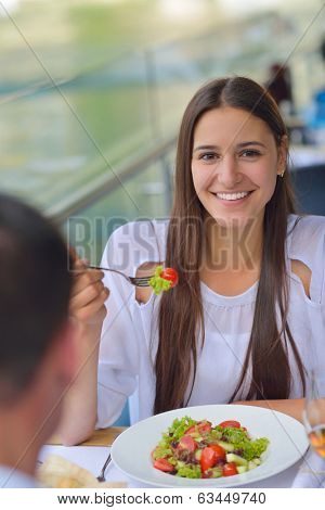 happy young couple having lanch at beautiful restaurant on by the sea on  beach