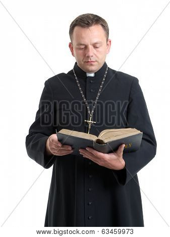 Catholic priest reading the Bible against a white background.