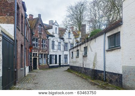 Traditional Buildings And Cobbled Street Bruges, Belgium