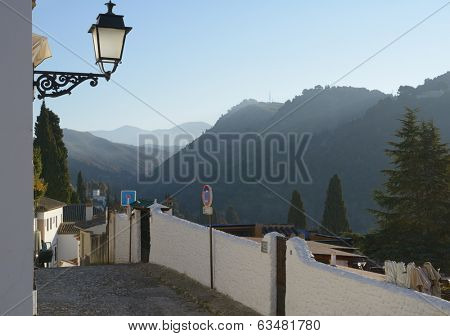 GRANADA, SPAIN - JANUARY 6, 2013: Narrow street of Albayzin in winter morning, This district of Granada was declared a world heritage site in 1984