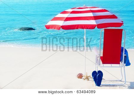 Beach Umbrella And Chair By The Ocean