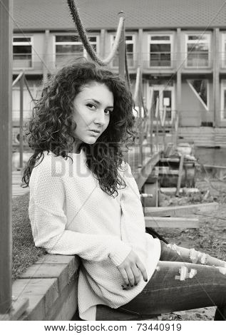 pretty girl sitting at city background in monochrome