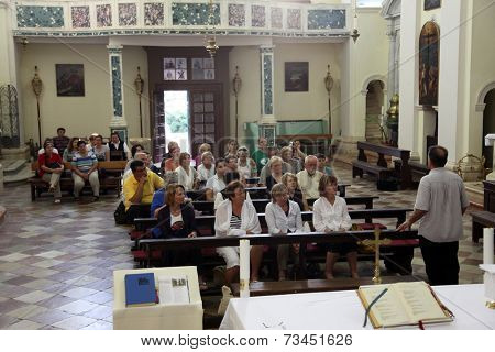 DOBROTA, MONTENEGRO - JUN, 9: Mass for pilgrims in the Catholic Church Saint Eustache. Kotor Bay is also known as the Bay of Saints, on Jun 9, 2012, in Dobrota, Montenegro