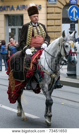 ZAGREB, CROATIA - OCTOBER 04: The parade of 70 participants, thirty horses and forty members of a brass band to the main square were announced next, 300th Sinjska Alka, on October 04, 2014 in Zagreb.