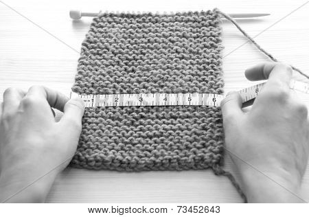 Two Hands Measuring Knitting In Inches