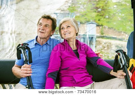 Senior hikers in cableway