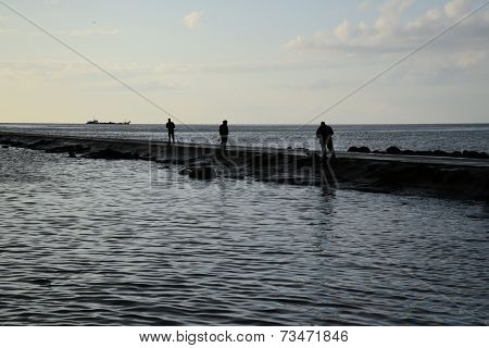 Fisher's silhouettes at pier