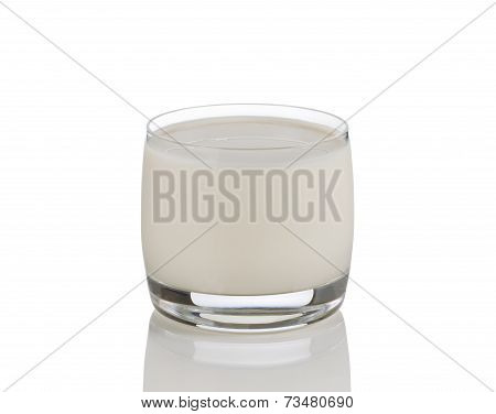 Full Glass Of Fresh Milk On White With Reflection