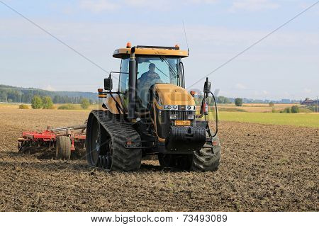 Challenger Agricultural Crawler Tractor On Field In Autumn