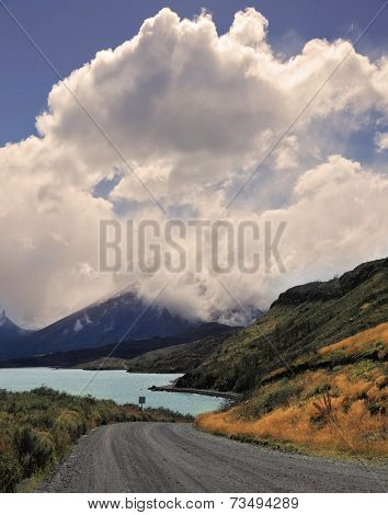 National Park in Chilean Patagonia - Torres del Paine. Gravel road bends along the shores of Lake Pehoe