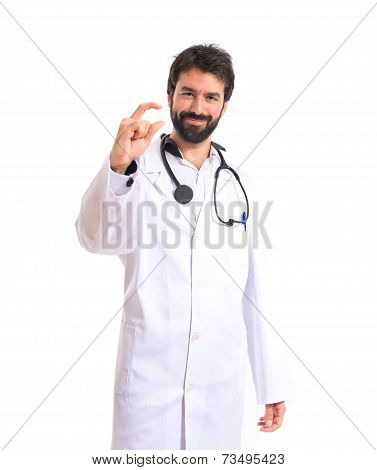 Doctor Doing Tiny Sign Over White Background