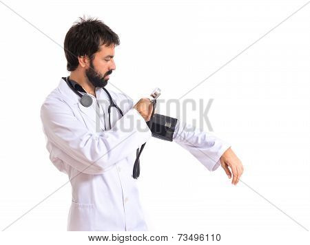 Doctor With Blood Pressure Monitor Over White Background