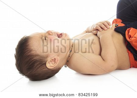 A baby is on a white background very sad and starting to cry.