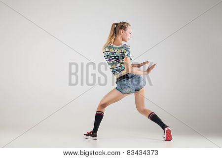 Beautiful booty dancer posing on studio background