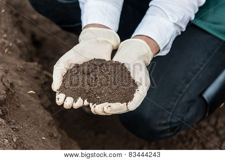 Technician woman hands holding soil