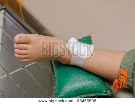 Child Boy With Bandage On Leg And Lying Down Hospital Bed