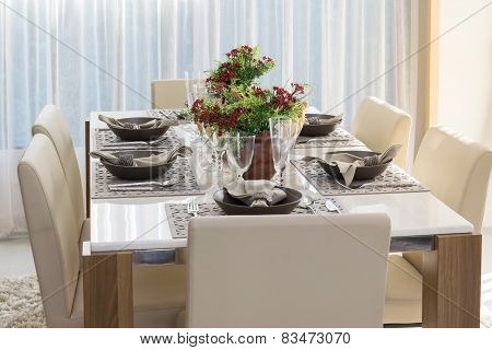 Dining Table And Comfortable Chairs In Modern Home With Elegant Table Setting