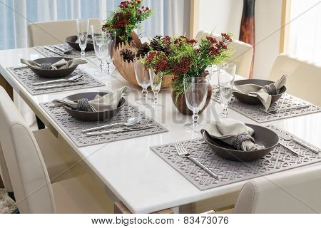 Dining Table And Comfortable Chairs In Modern Home With Elegant Table Setting