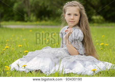 Girl Sitting In The Park And Posing