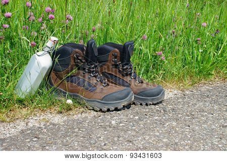 Hiking Boots In Front Of A Summer Meadow