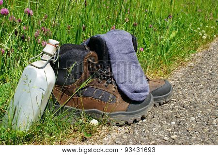 Hiking Boots In Front Of A Summer Meadow
