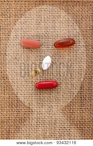 Drug Pill On The Burlap Human Sick Face Form